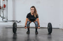 A woman doing a clean and jerk